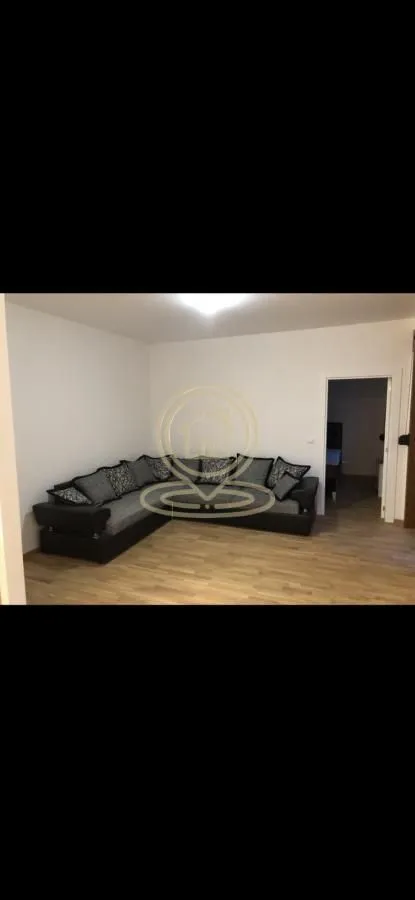 Living room with a corner sofa and laminate flooring.