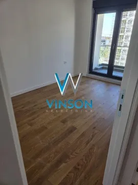 Empty room with wooden flooring and access to the terrace. - image 6