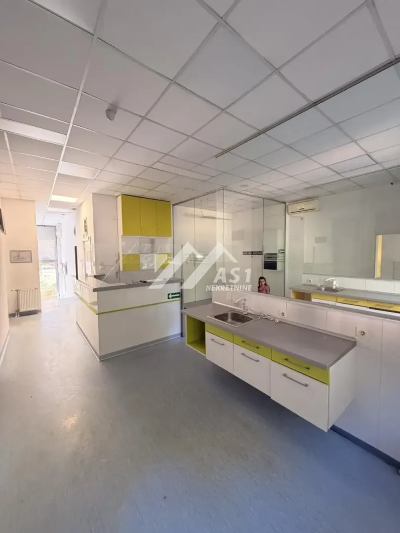 Kitchen equipped with white and yellow units featuring a sink and a countertop.