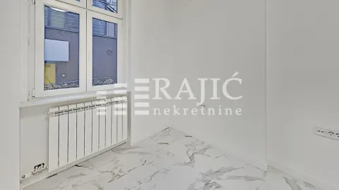 Empty room with white walls and marble tile flooring. - image 16