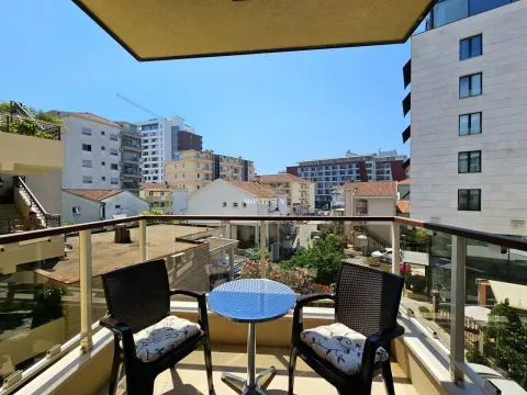 Furnished balcony with seating set and city view. - image 9