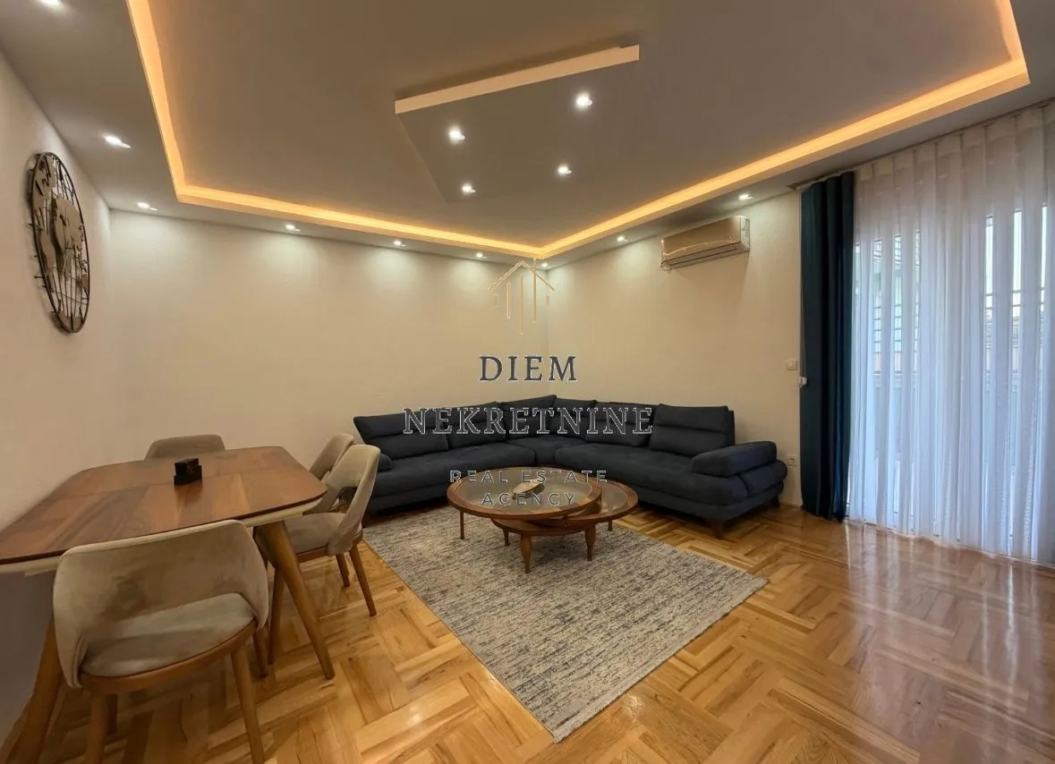 Living room with a sofa and dining area.
