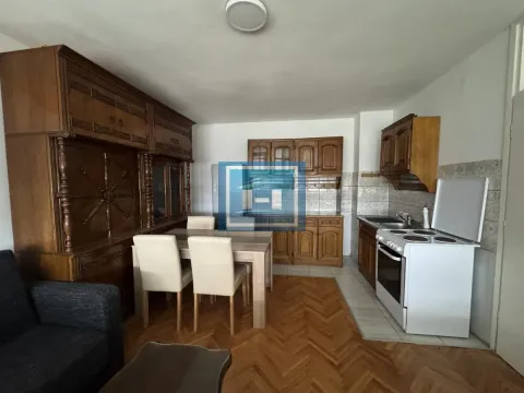Kitchen with dining area equipped with wooden cabinets and parquet flooring. - image 7