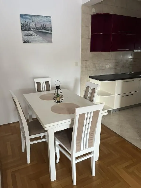 Dining table with chairs near the kitchen.