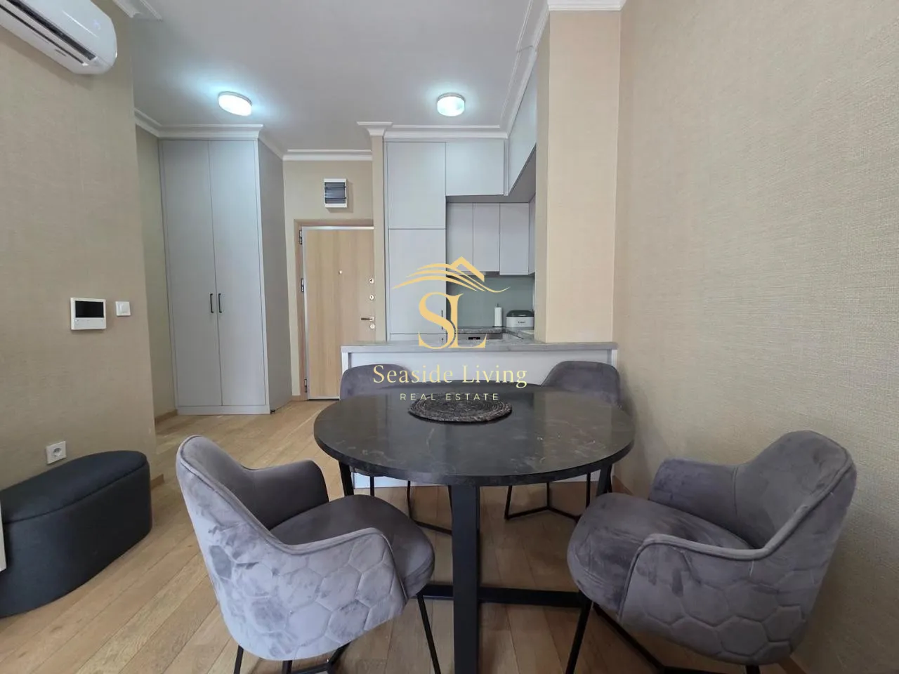 Living room with a dining area and kitchen in the background.