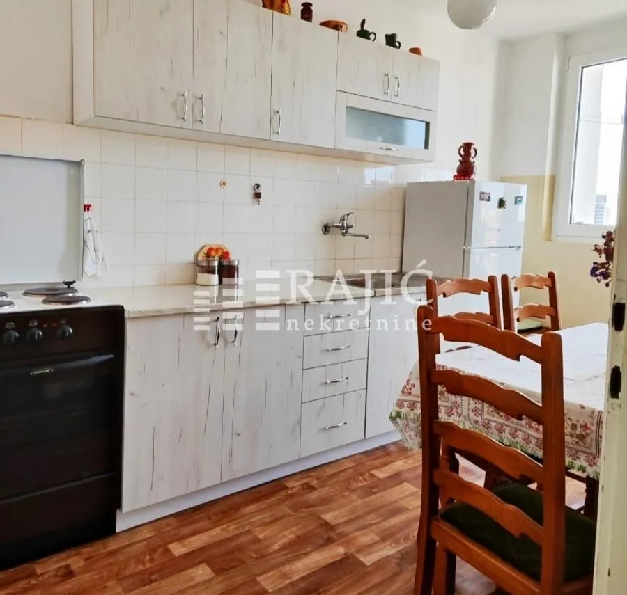 Kitchen with a dining area and wooden cabinetry.
