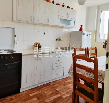 Kitchen with a dining area and wooden cabinetry. - image 6