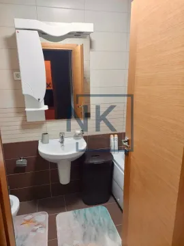 Bathroom equipped with a washbasin, mirror, and toilet. - image 6