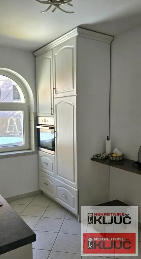 Part of the kitchen with built-in units and an oven.