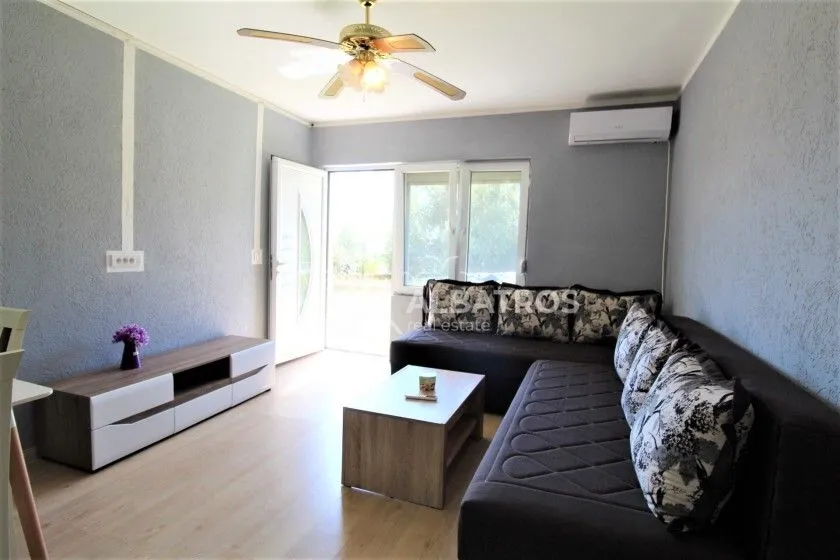 Living room with a sofa set, coffee table and TV unit.