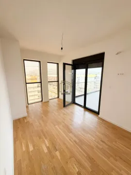 Empty bright room with hardwood flooring and access to the terrace. - image 8