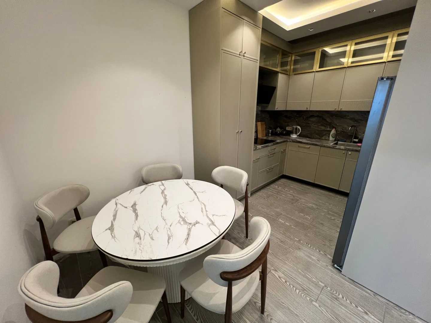 Modern kitchen with a dining table and chairs.