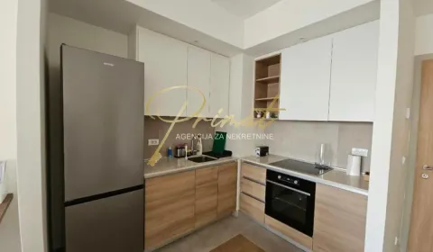 Kitchen equipped with wooden base cabinets and white upper cabinets. - image 4
