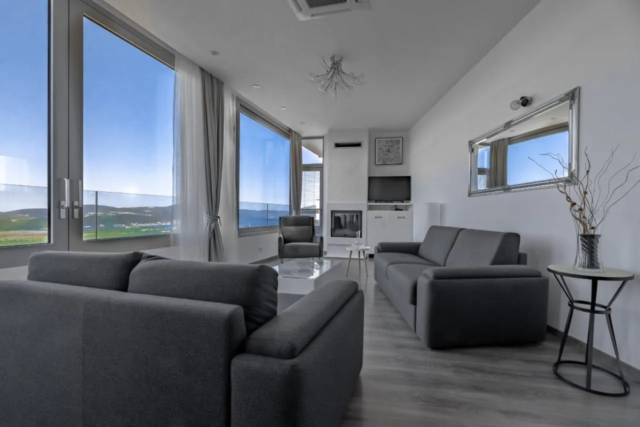 Spacious and bright living room with a sofa set and sea view.