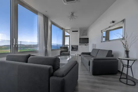 Spacious and bright living room with a sofa set and sea view. - image 17