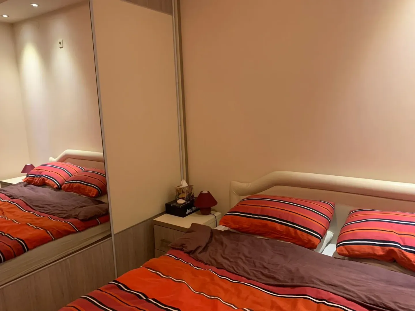Furnished bedroom with a double bed and built-in wardrobe.