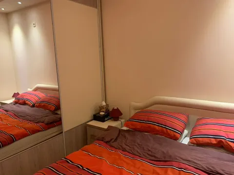 Furnished bedroom with a double bed and built-in wardrobe. - image 7