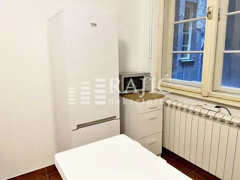 Smaller kitchen with a refrigerator and a window. - image 8
