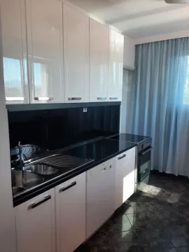 Kitchen with white cabinetry, dark countertops, and a sink. - image 19