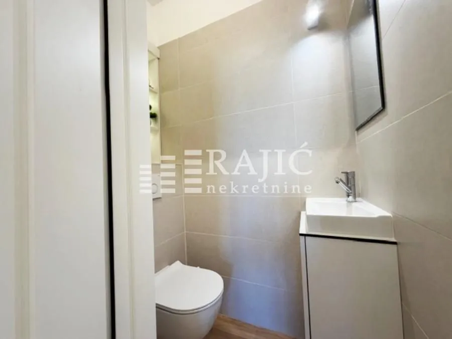 Smaller bathroom with a sink and a toilet bowl.