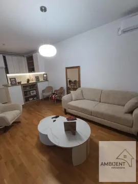 Dnevna soba sa garniturom, stočićem i kuhinjom u pozadini. - image 9