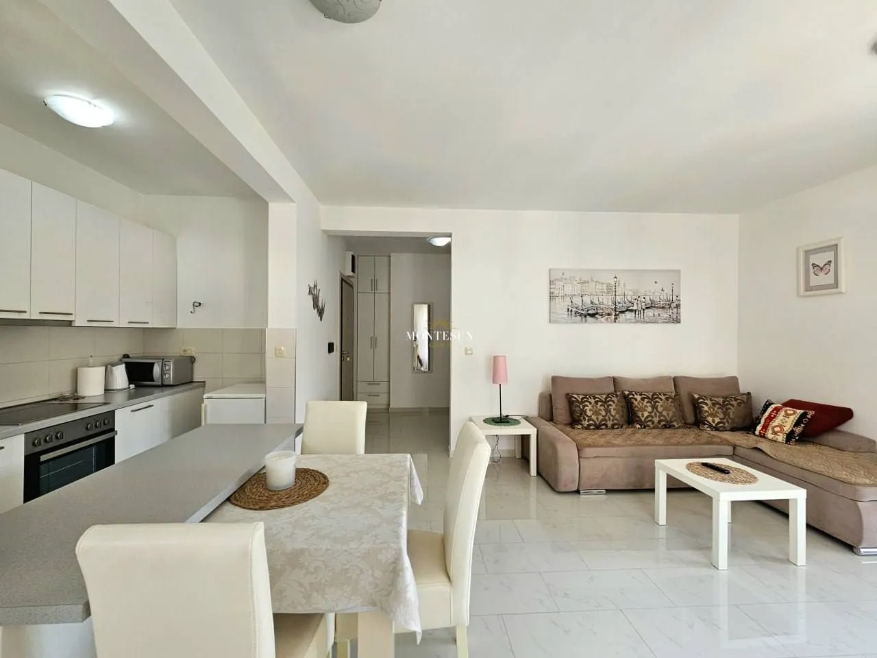 Living room with dining area and open-plan kitchen.