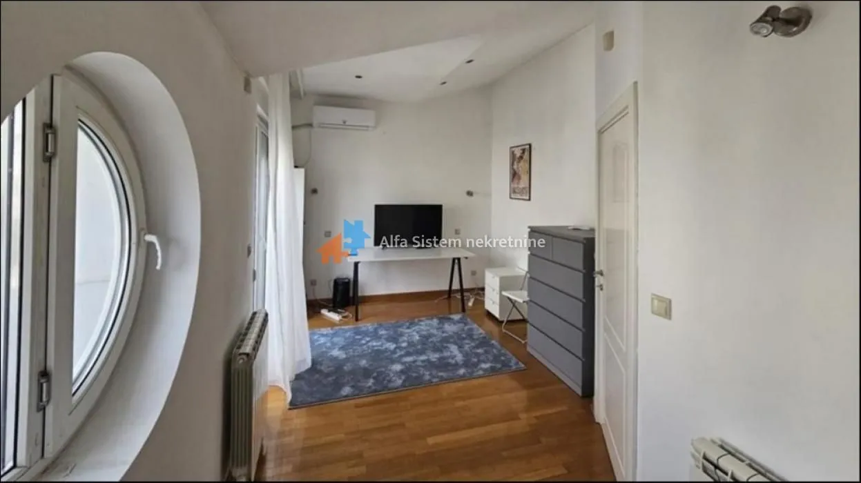 Small living room with a desk and TV.