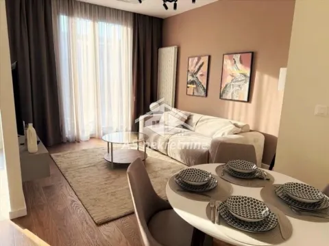 Living room with a sofa, dining table, and access to the terrace. - image 16