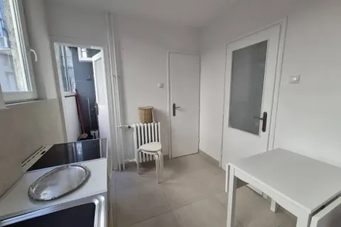 Small kitchen with a dining table and balcony access. - image 8
