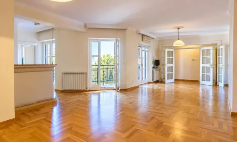 Spacious empty living room with parquet flooring and access to a balcony. - image 6