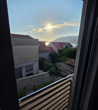 View from the terrace overlooking surrounding houses, hills, and the sea in the distance. - image 9
