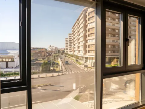 View through the window of the street and buildings in the neighborhood. - image 9