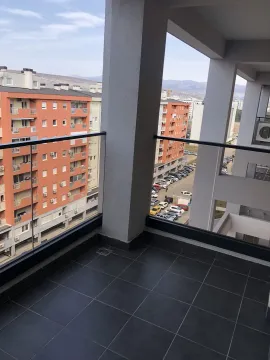 Spacious terrace with glass railing and neighborhood view. - image 35