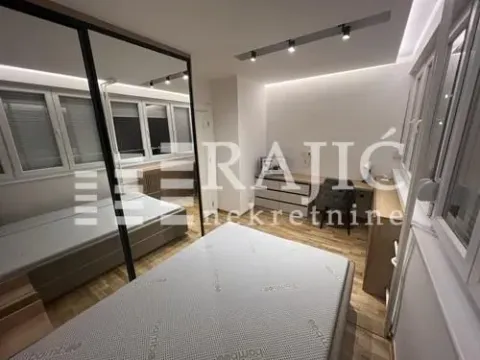 Modern bedroom with a bed, large wardrobe, and desk. - image 6