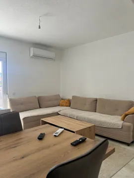 Living room with a corner sofa, coffee table and dining table. - image 8