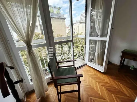 Bright room with wooden flooring and balcony access. - image 2