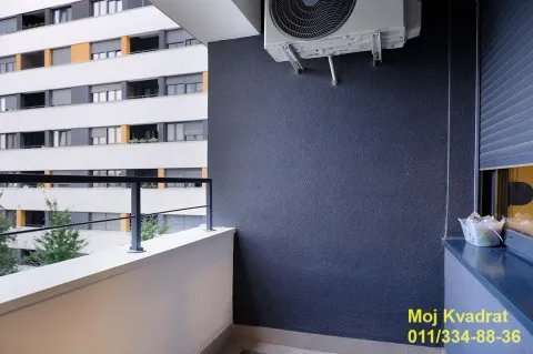 View from the balcony overlooking surrounding buildings and an air conditioning unit on the wall. - image 15