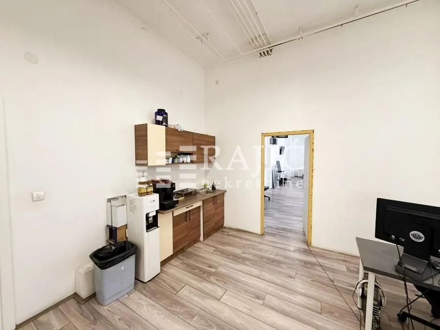 Small kitchen in an office space with wooden cabinets.