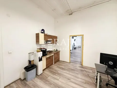 Small kitchen in an office space with wooden cabinets. - image 9