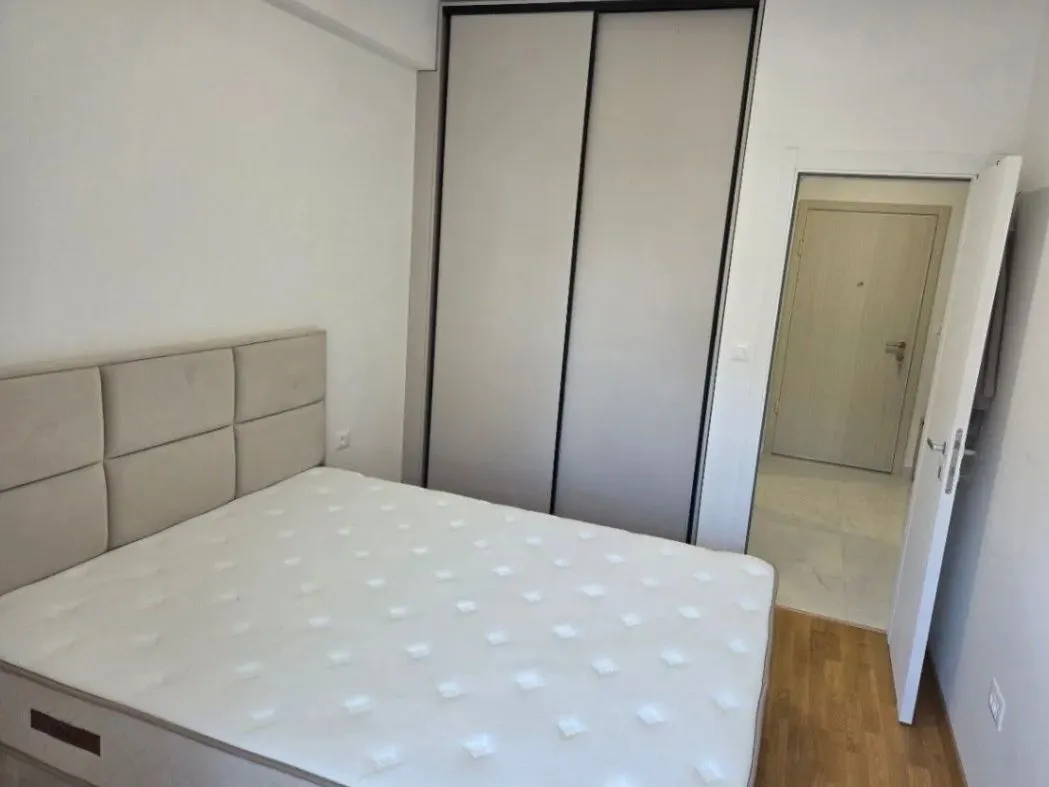 Bedroom with a double bed, wardrobe, and a view of the hallway.