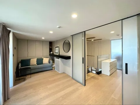 Living room with a sofa and sliding glass doors. - image 10