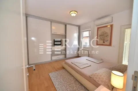 Furnished bedroom with a double bed, wardrobe, and air conditioning. - image 8