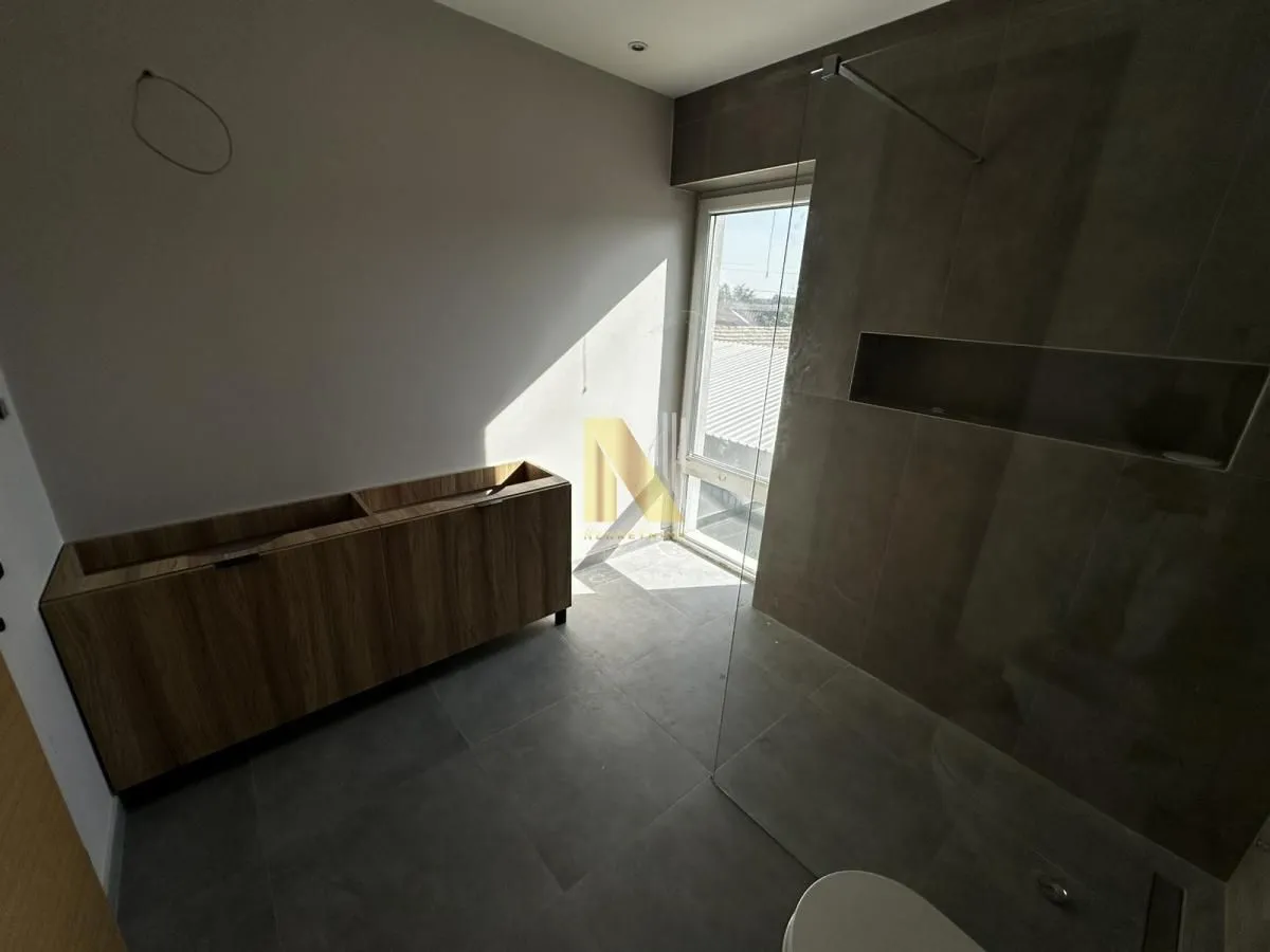 Modern bathroom with a walk-in shower and vanity.
