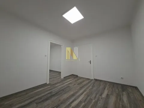 Empty room with laminate flooring and white walls. - image 4