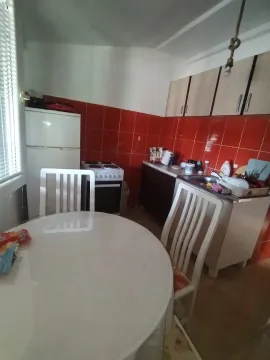 Smaller kitchen with a dining table and chairs. - image 6