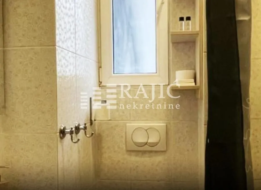Smaller bathroom with a walk-in shower and built-in fixtures.