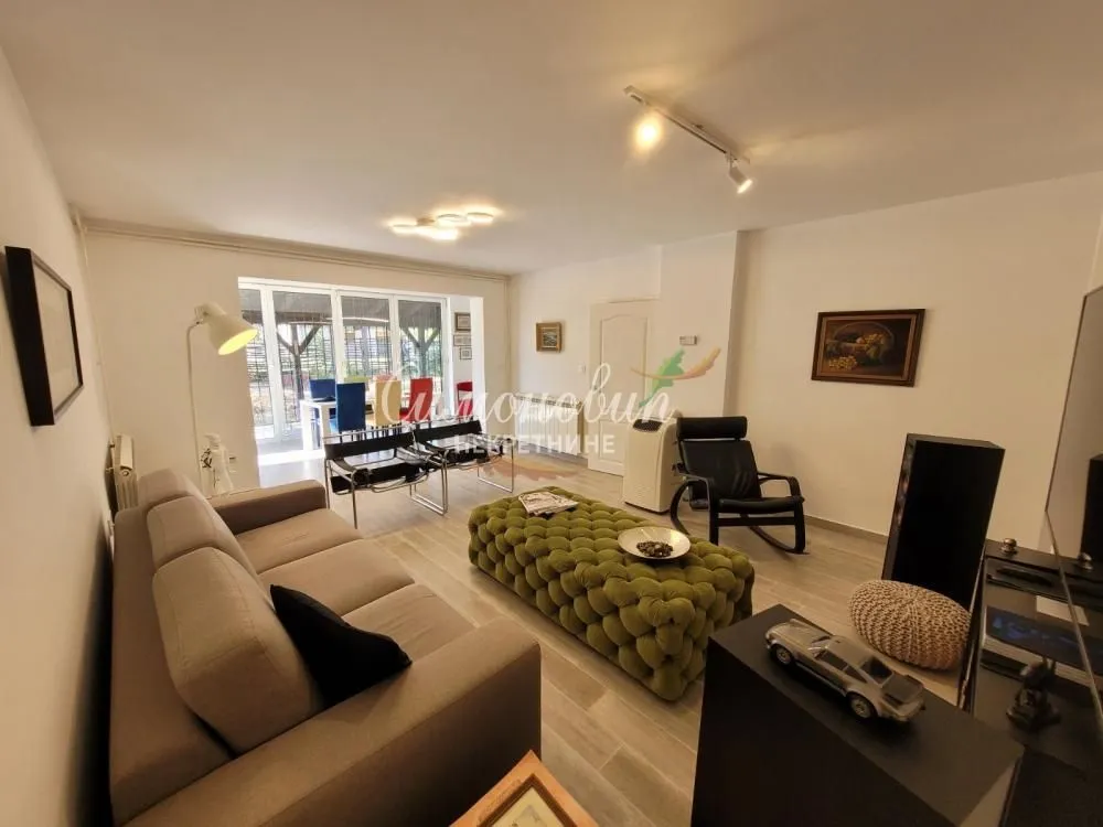 Living room with sofa, armchairs and access to the terrace.