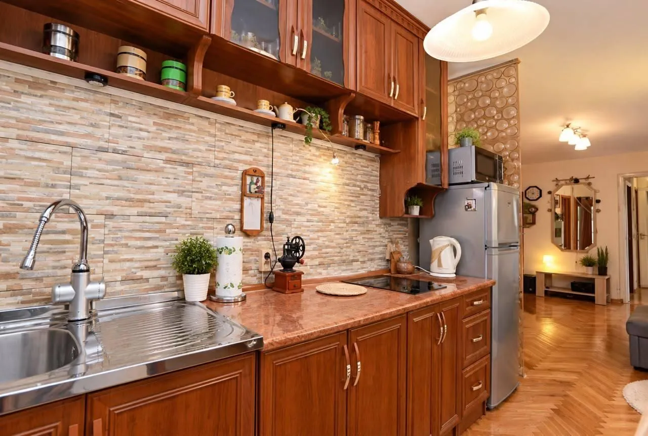 Kitchen with wooden cabinetry, a sink, and a countertop.