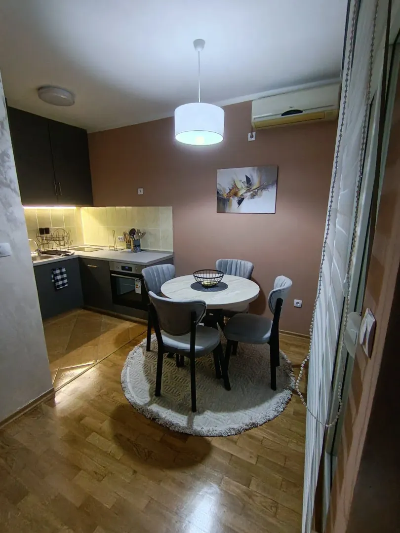 Dining area with a table and chairs connected to the kitchen.