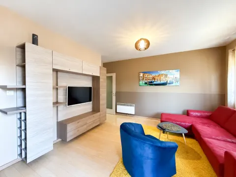 Living room with sofa, TV unit, and sitting area. - image 2